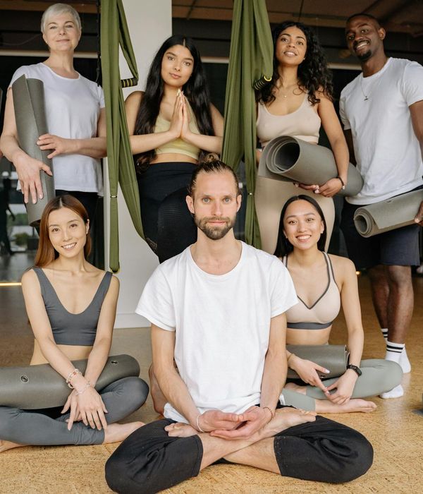 Diverse group of people smiling after a yoga class.